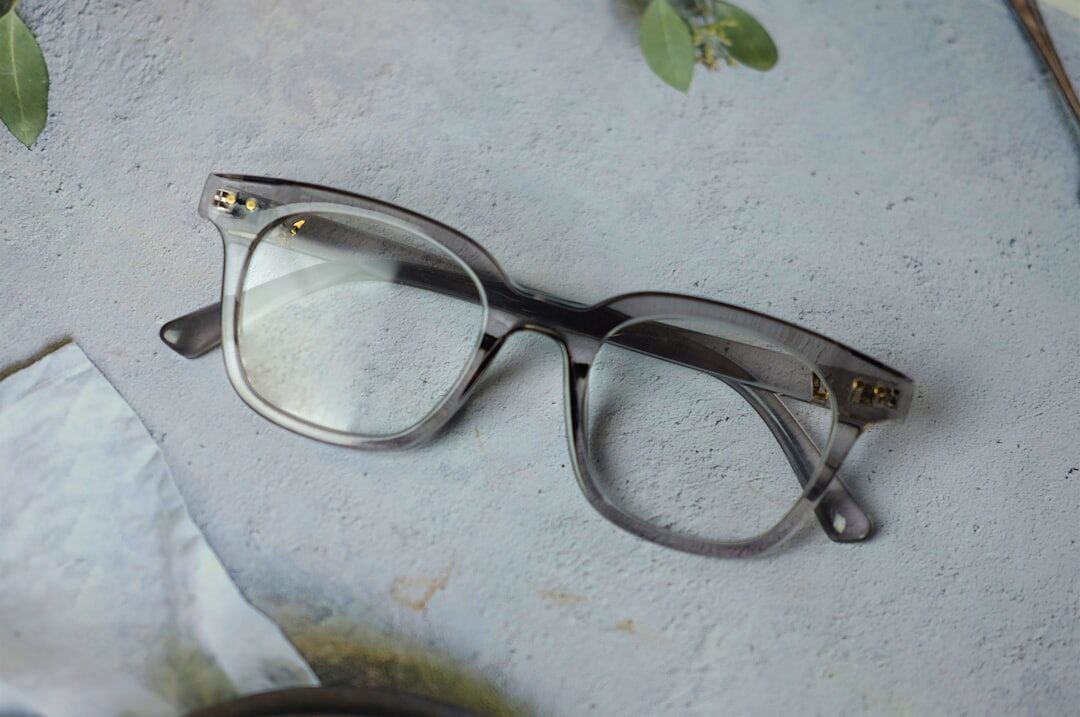 Close-up of handcrafted acetate eyeglasses frames on a neutral surface